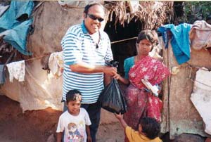 A man giving a bag of food to children